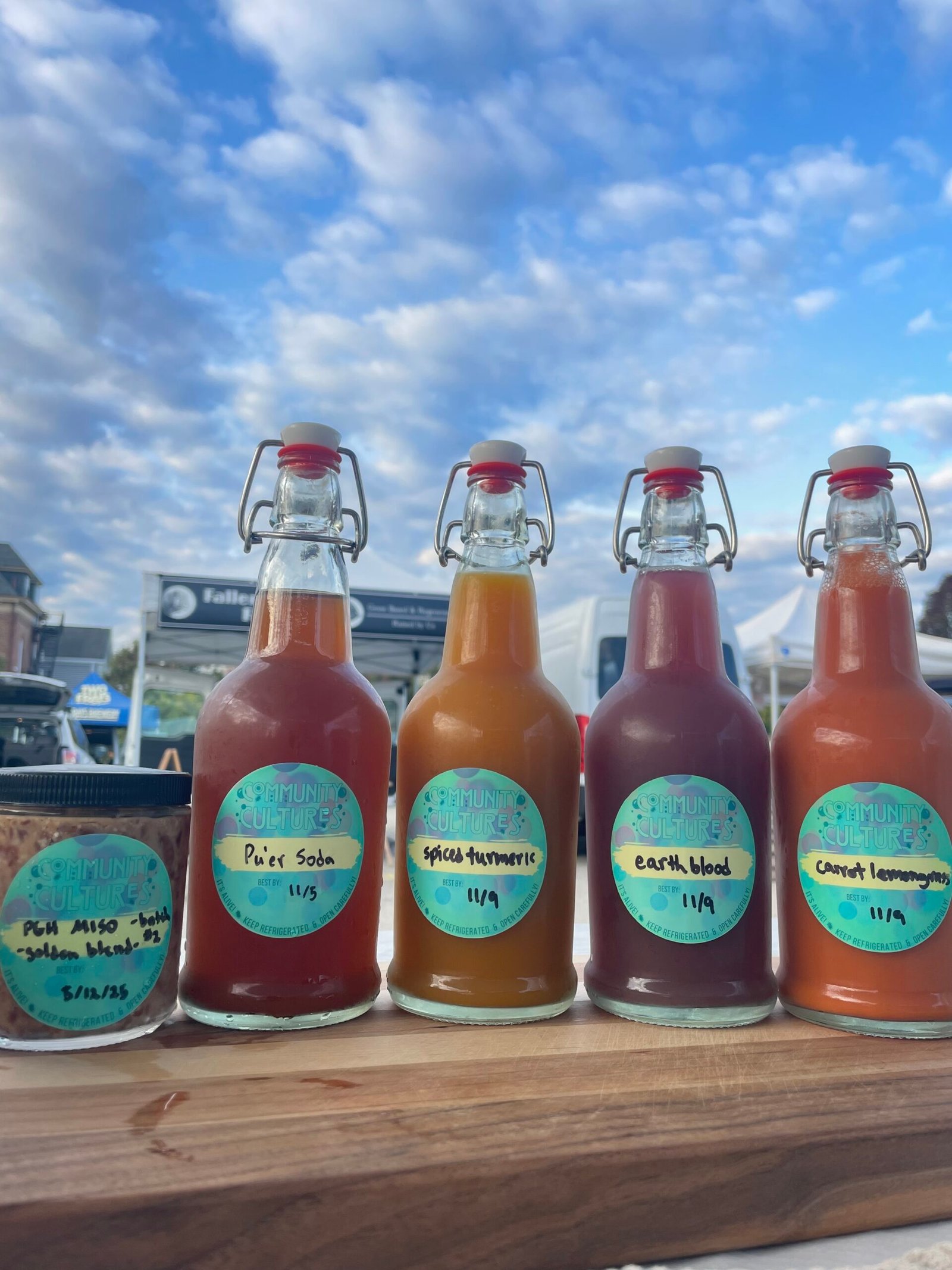 Colorful, flavored, live-cultured soda bottles under the blue sky.